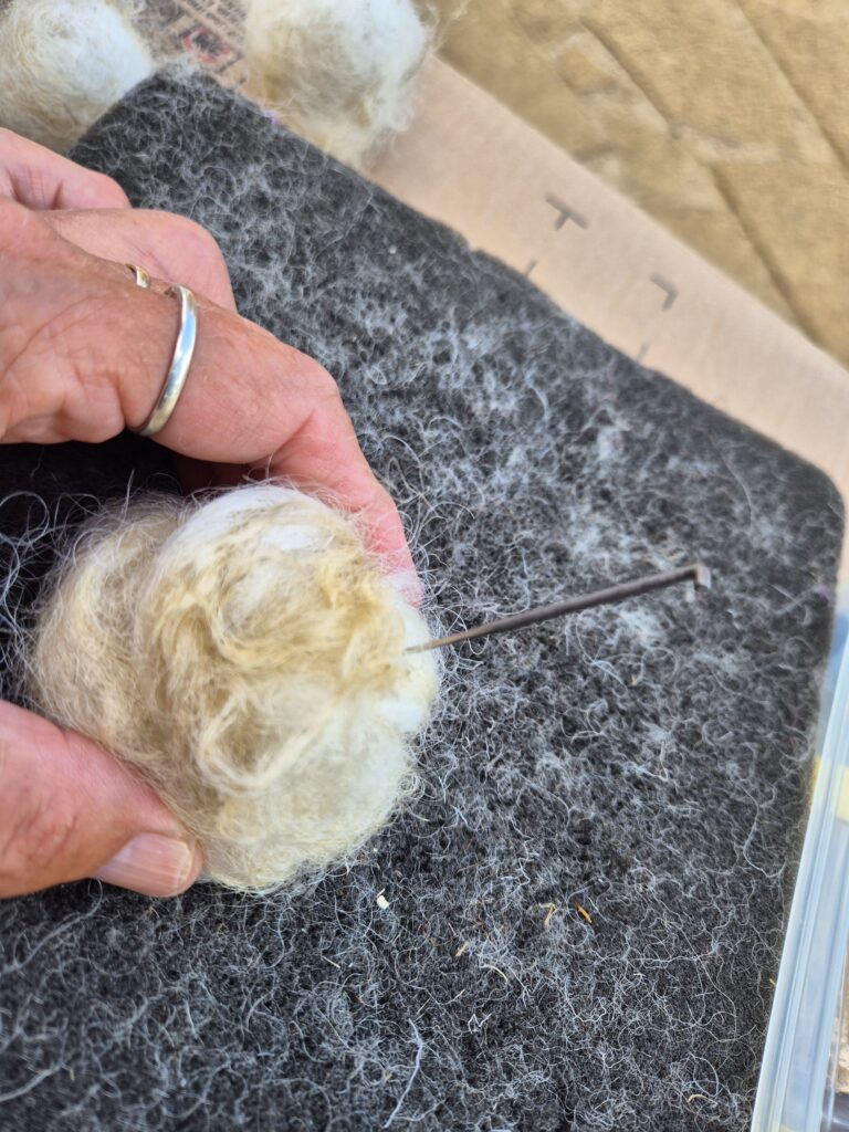Needle felted grubby fleece into a firm ball